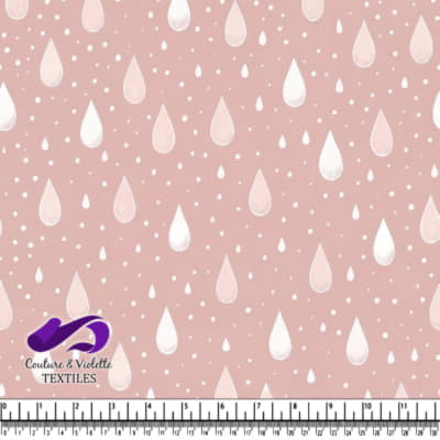 Soft pink fabric with white raindrop pattern design