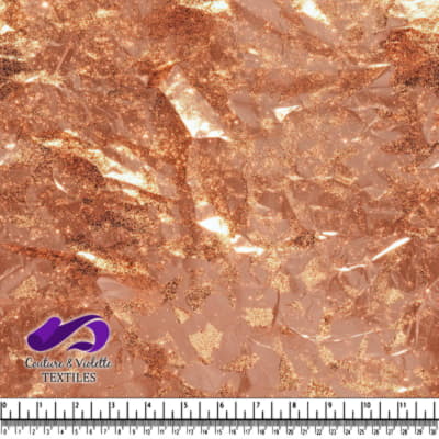 Shiny rose gold foil textured fabric with an irregular organic pattern
