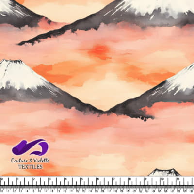 Snow capped mountains with orange misty sky background